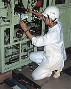 [写真]女子オペレーターによる加工機械の点検（富士宮工場）